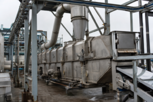 Vibrating fluid bed dryer with overhead cyclone and dust ducting in a salt plant