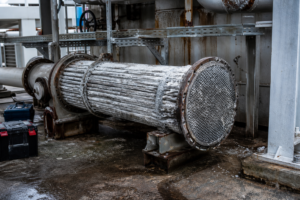 Heat exchanger tube bundle heavily coated with white calcium scale removed for maintenance